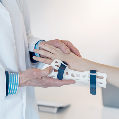 Clinical check-up: doctor examining patient wearing a scoliosis brace